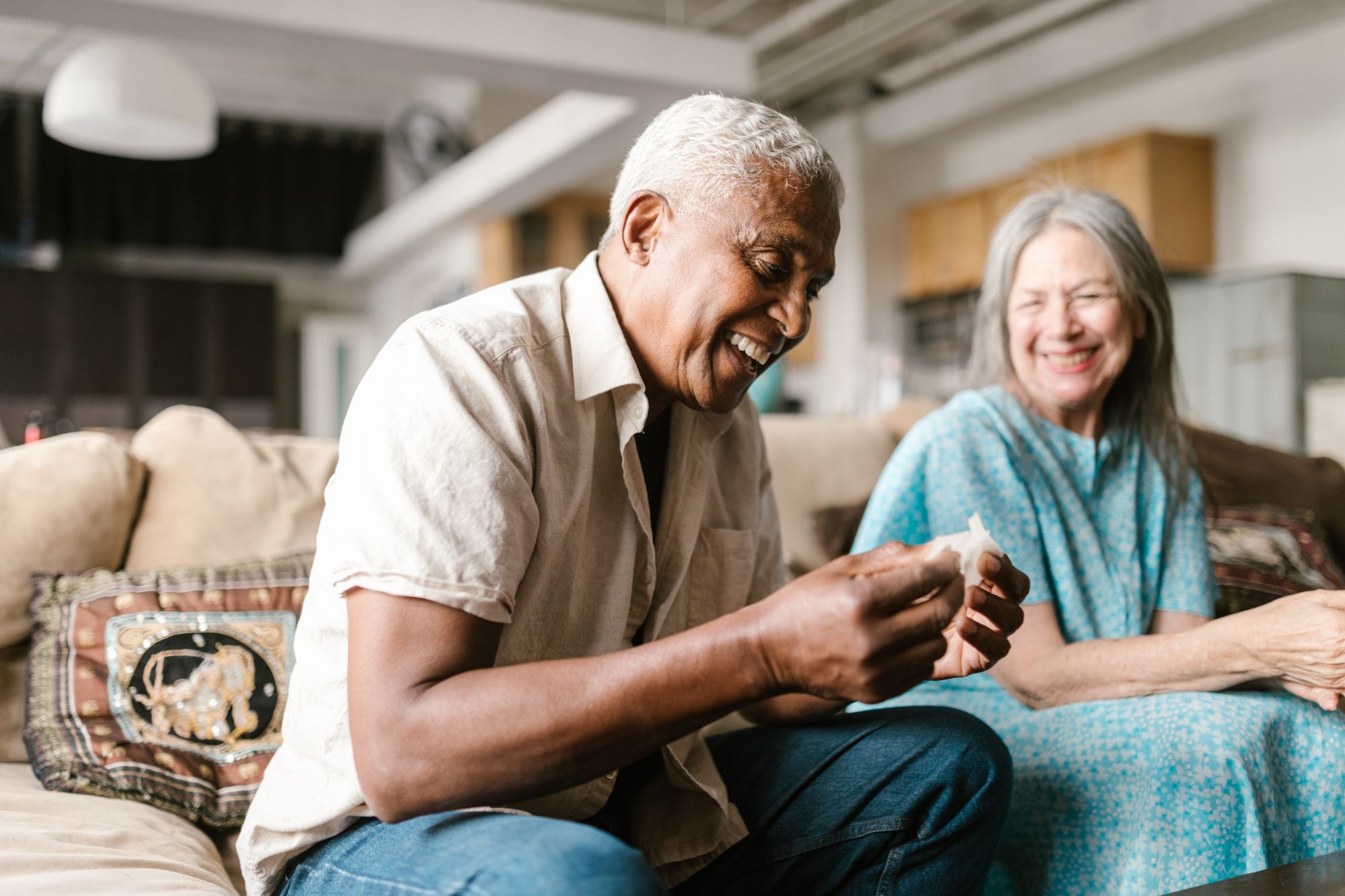 A couple in their sixties laughing together at home